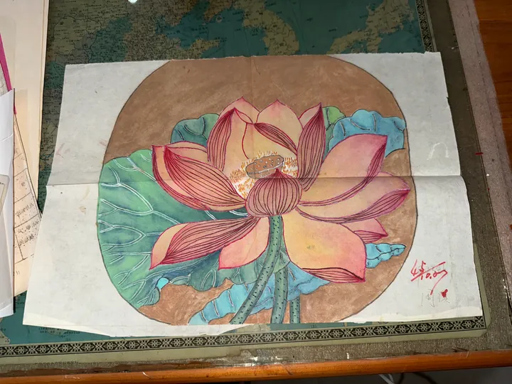 A painting on paper of an open lotus flower and its leaves.