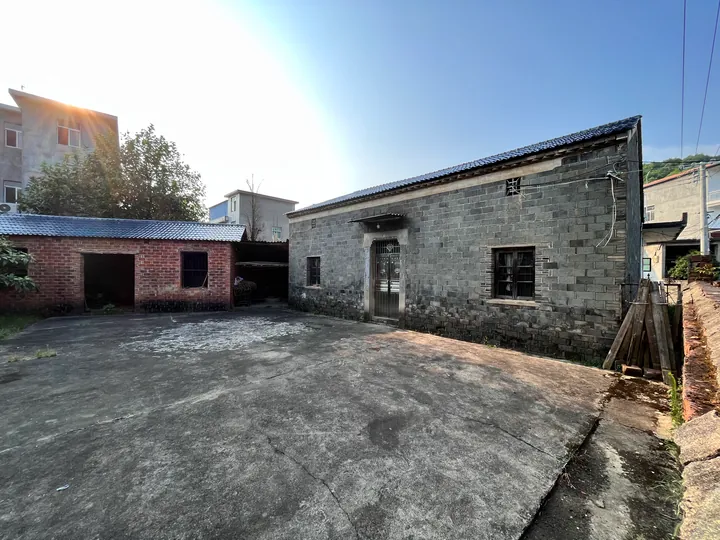 A sunlit courtyard surrounded by brick buildings.