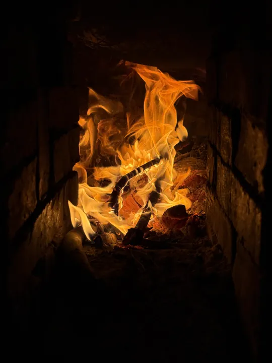 Wood and flames inside a stove.