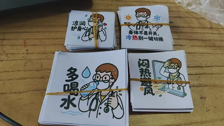 Stacks of illustrated reminder cards about drinking water and staying cool.