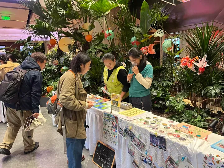 A closer view of people discussing climate and health materials at a table.