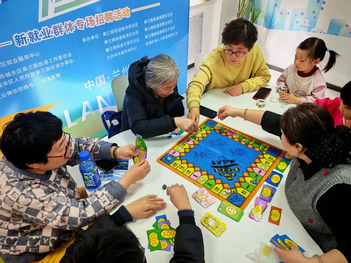 Participants of different ages gathered around a tabletop activity.